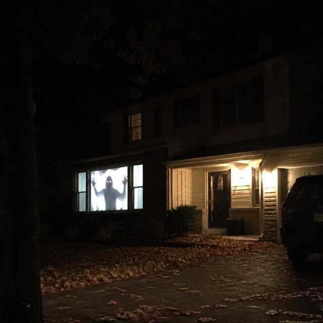 Customer photo of the projection in a front window at night