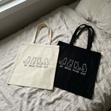 Violet D.'s cream and black totes